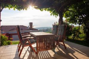 a wooden table and two chairs on a patio at Seaview Heights above Portorož in Izola