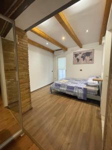 a bedroom with a bed and a wooden floor at L'ANTICA FALCONERIA in Iesi