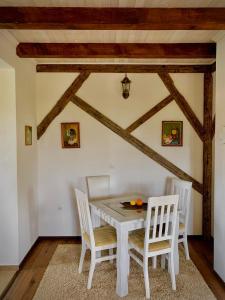 a dining room with a white table and chairs at Silent Village Villa with Swimming Pool in Mostar