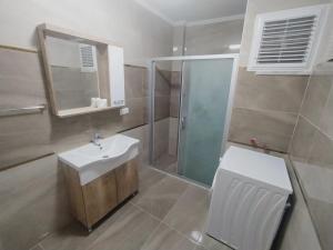 a bathroom with a sink and a shower and a toilet at Kaya House Daily Flat in Ortaca +45 photos