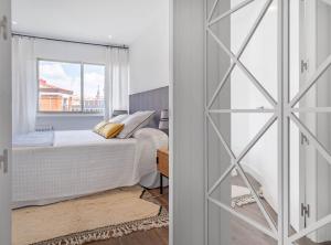 a bedroom with a bed and a window at Principe de Vergara I in Madrid