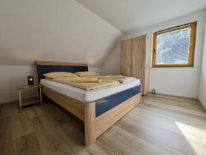 a bedroom with a bed and a window at Apartments Irena in Bohinj