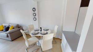 a living room with a table and chairs and a couch at Casa Principe J-A Murcia Holiday Rentals Property in Roldán