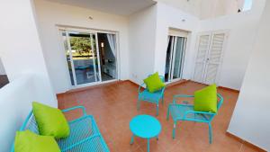 a room with blue chairs and a table and green pillows at Casa Principe J-A Murcia Holiday Rentals Property in Roldán