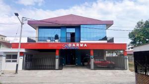 a building with a car parked in front of it at Darma Palace Syariah in Padang