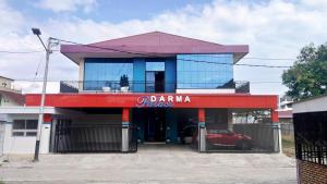 a building with a car parked in front of it at Darma Palace Syariah in Padang +5 photos