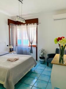 a bedroom with a bed and a blue tile floor at Sorrento Moon in Sorrento