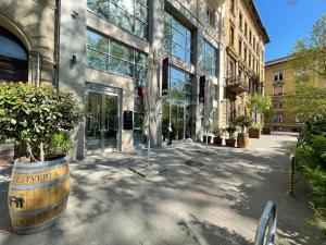 a building with a large barrel with a tree in it at Smart Hotel Budapest & Apartments in Budapest