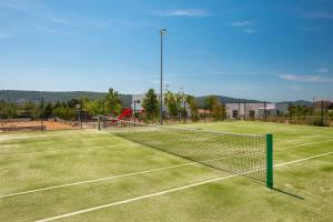 un campo da tennis con rete su un campo di Villa Promissa Terra a Dubrava