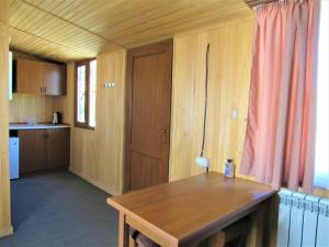 a kitchen with a wooden table in a room at Arpa Valley Cabin in Yeghegnadzor