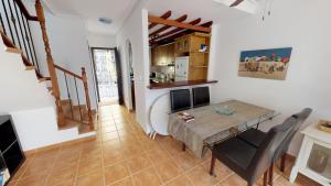a kitchen and dining room with a table and chairs at Casa Rozalejo - A Murcia Holiday Rentals Property in San Javier