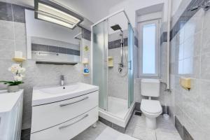 a bathroom with a sink and a toilet and a shower at Apartment light in Pula in Pula