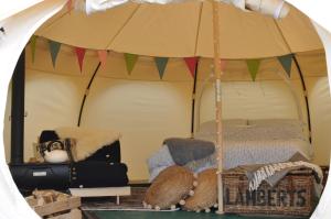 a room with a tent with a bed in it at Lovely spacious lotus bell tent in Shaftesbury UK in Shaftesbury