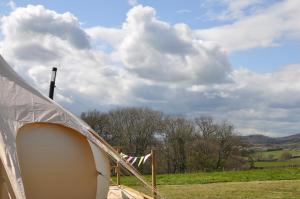 a close up of a tent in a field at Lovely spacious lotus bell tent in Shaftesbury UK in Shaftesbury