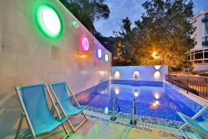 two chairs and a swimming pool at night at Villa Katarina in Budva