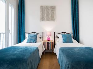 Un pat sau paturi într-o cameră la Bailen Palacio Real