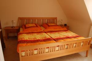 a bedroom with a wooden bed with two pillows at Ferienwohnung Heinrichseck in Bamberg