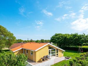 a small yellow house with an orange roof at 6 person holiday home in Hemmet in Hemmet