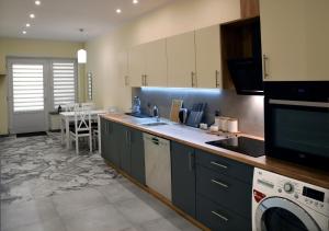 a kitchen with a sink and a dishwasher at APARTAMENT KOTLINKA in Jasło