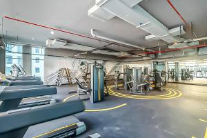 a gym with treadmills and machines in a room at Cozy Yet Stylish Unit Studio One Marina in Dubai