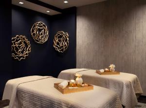 two beds in a room with white linens and art on the wall at Grand Hyatt Nashville in Nashville