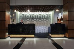 a man standing at a podium in a lobby at NH Mexico City Valle Dorado in Mexico City