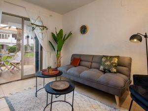 a living room with a couch and two tables at Apartment Nueva Playa-1 by Interhome in Les Deveses	