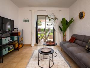 a living room with a couch and a tv at Apartment Nueva Playa-1 by Interhome in Les Deveses	 +33 photos