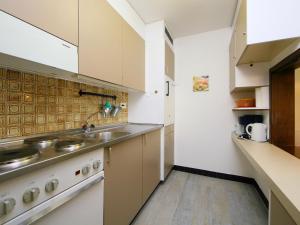 a kitchen with a sink and a stove at Apartment Ringstrasse - Utoring-22 by Interhome in Leukerbad