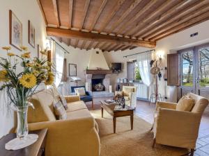 a living room with a couch and chairs and a fireplace at Holiday Home Villa del Poggio by Interhome in Radda in Chianti