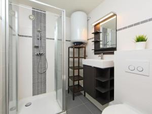 a bathroom with a shower and a toilet and a sink at Studio Residentie Astrid-5 by Interhome in Bredene