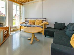 a living room with a couch and a table at Holiday Home Kylämattila by Interhome in Ilola