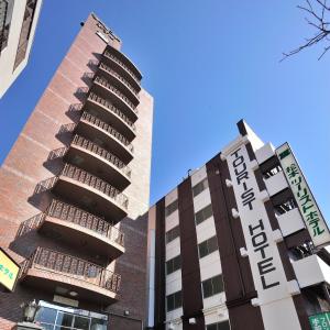 a building with a sign on the side of it at Matsumoto Tourist Hotel in Matsumoto