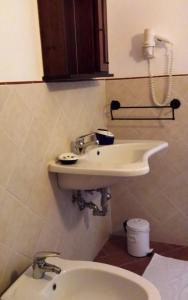 a bathroom with a sink and a toilet at Agriturismo Il Cantastorie in Montepulciano