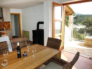 a dining room with a table with wine glasses on it at Holiday Home Jure by Interhome in Mrljane
