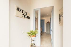 a hallway of an office building with a sign on the wall at B&B Antico Telaio in Santa Maria Navarrese