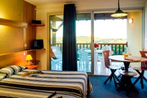 Ein Bett oder Betten in einem Zimmer der Unterkunft Résidence Les Hauts de Marquay