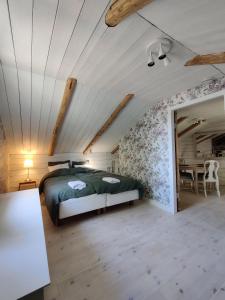 a bedroom with a bed and a table in a room at Villa Reuter in Stormälö