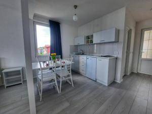 a kitchen with a table and a dining room at First line apartment in Ohrid