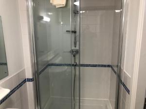 a shower with a glass door in a bathroom at Whalley Abbey - Christian Retreat House offering B&B in Whalley