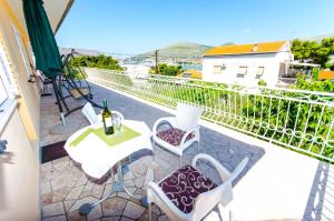 a patio with a table and chairs on a balcony at Apartments Ivana in Trogir