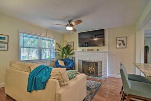 a living room with a couch and a fireplace at Cozy Jungle Escape Less Than 1 Mi to Gulfport Beach! in St Petersburg