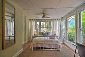 a bedroom with a bed in a room with windows at Cozy Jungle Escape Less Than 1 Mi to Gulfport Beach! in St Petersburg