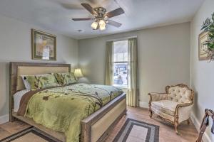 a bedroom with a bed and a ceiling fan and a chair at Crescent City Apartment with Easy Lake Access! in Crescent City
