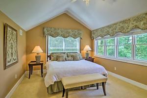 a bedroom with a large bed and two windows at Mountain View Home Hike, Raft, Golf and More! in Bryson City