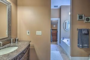 a bathroom with a sink and a mirror and a tub at Mountain View Home Hike, Raft, Golf and More! in Bryson City +35 photos