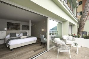 a bedroom with a bed and a balcony at Sublimis Boutique Hotel Adults-Only in Camogli