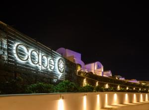 a building with lights on the side of it at night at CAPE 9 Villas & Suites in Akrotiri +50 photos