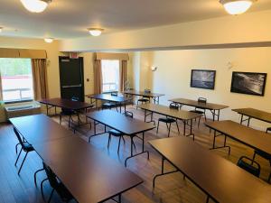an empty classroom with wooden tables and chairs at Super 8 by Wyndham Amherst NS in Amherst