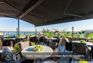 ein Restaurant mit Tischen und Stühlen und Meerblick in der Unterkunft Sadaret Hotel&Suites Istanbul -Best Group Hotels in Istanbul